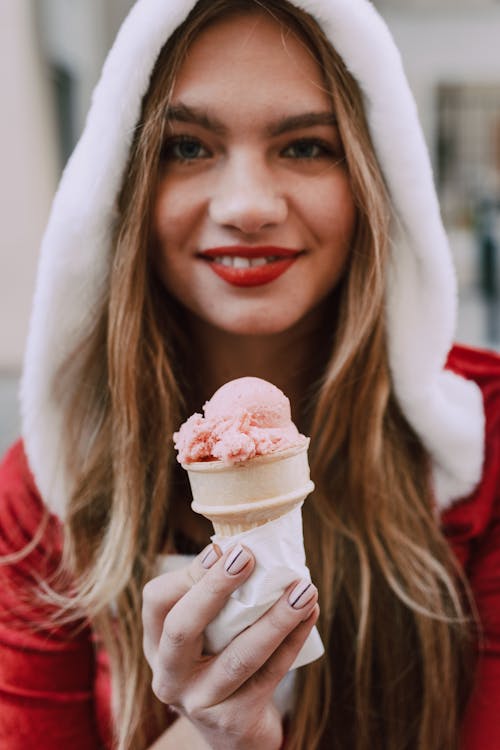 Woman in Red Shirt Holding Ice Cream Cone