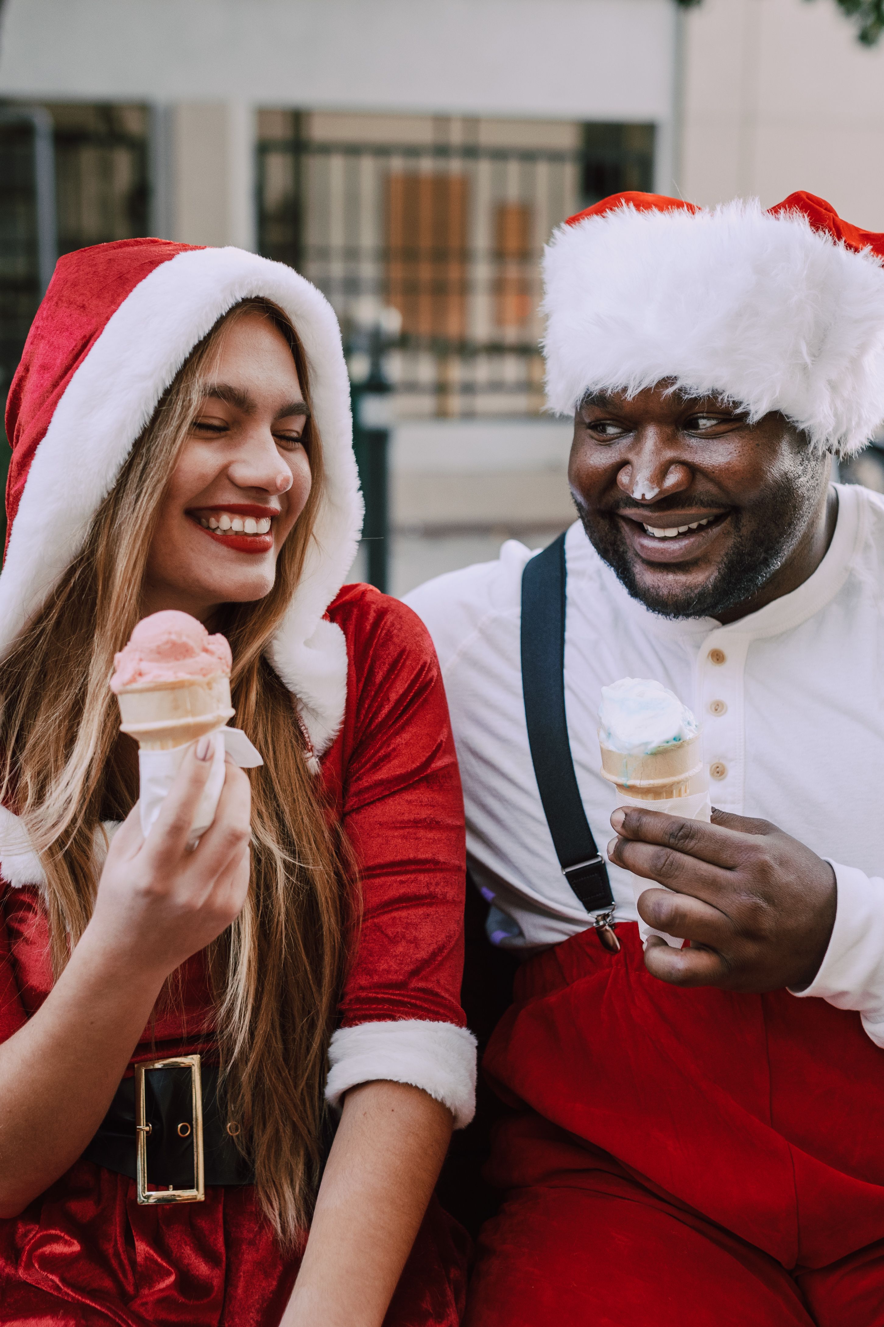 Man and Woman in Santa Costume Holding an Ice Cream · Free Stock Photo