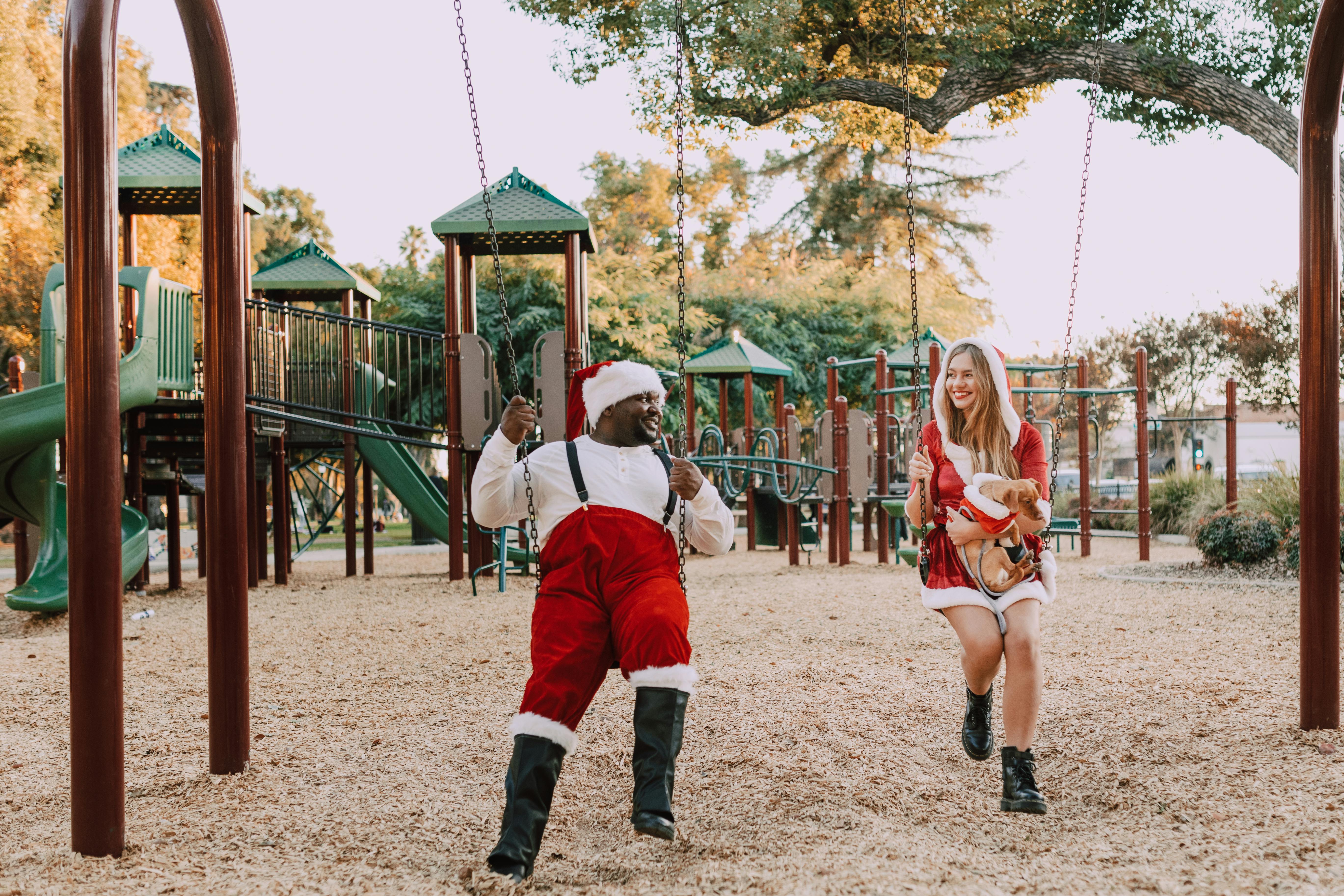 girl in red jacket sitting on swing