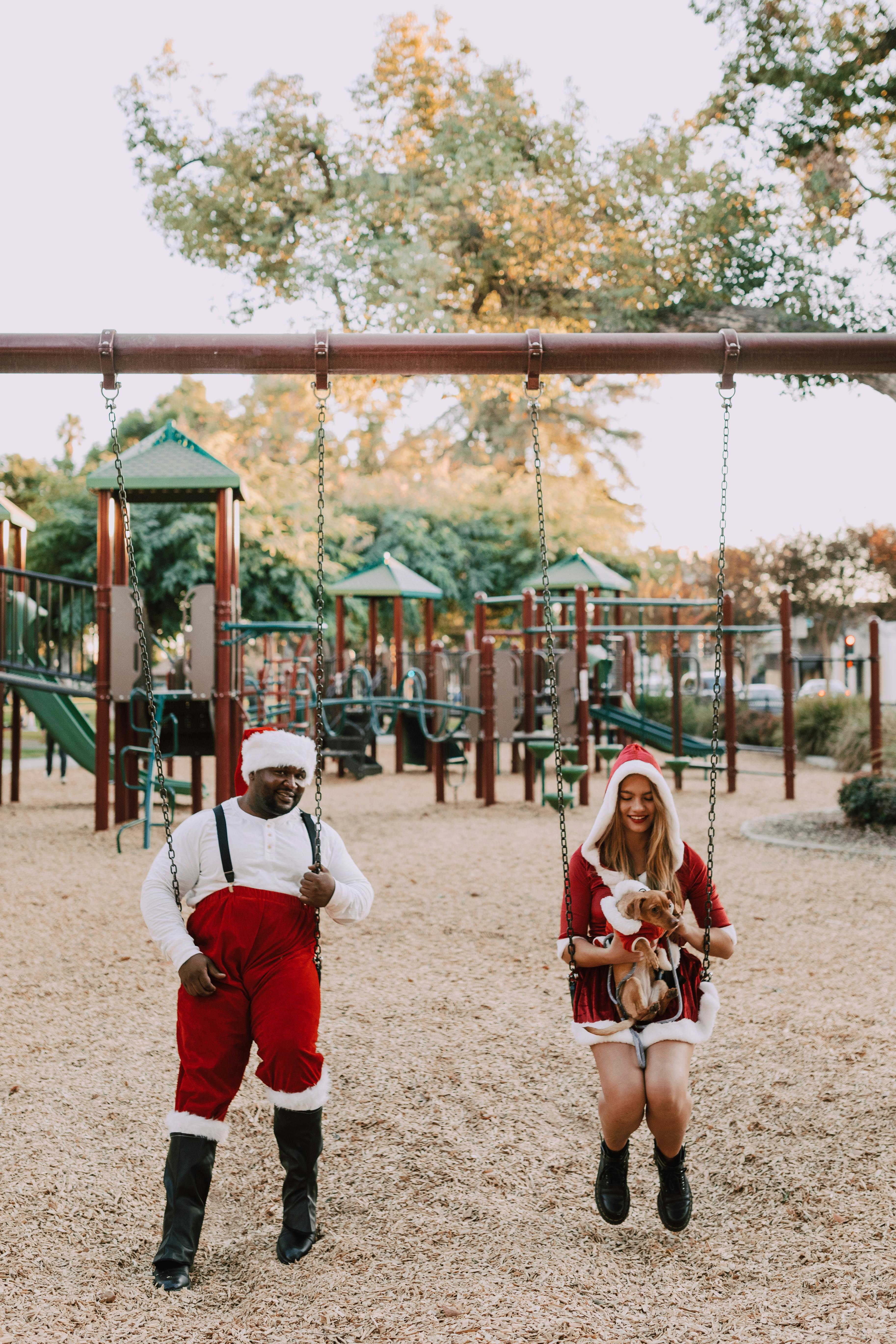 girl in white shirt and red pants sitting on swing