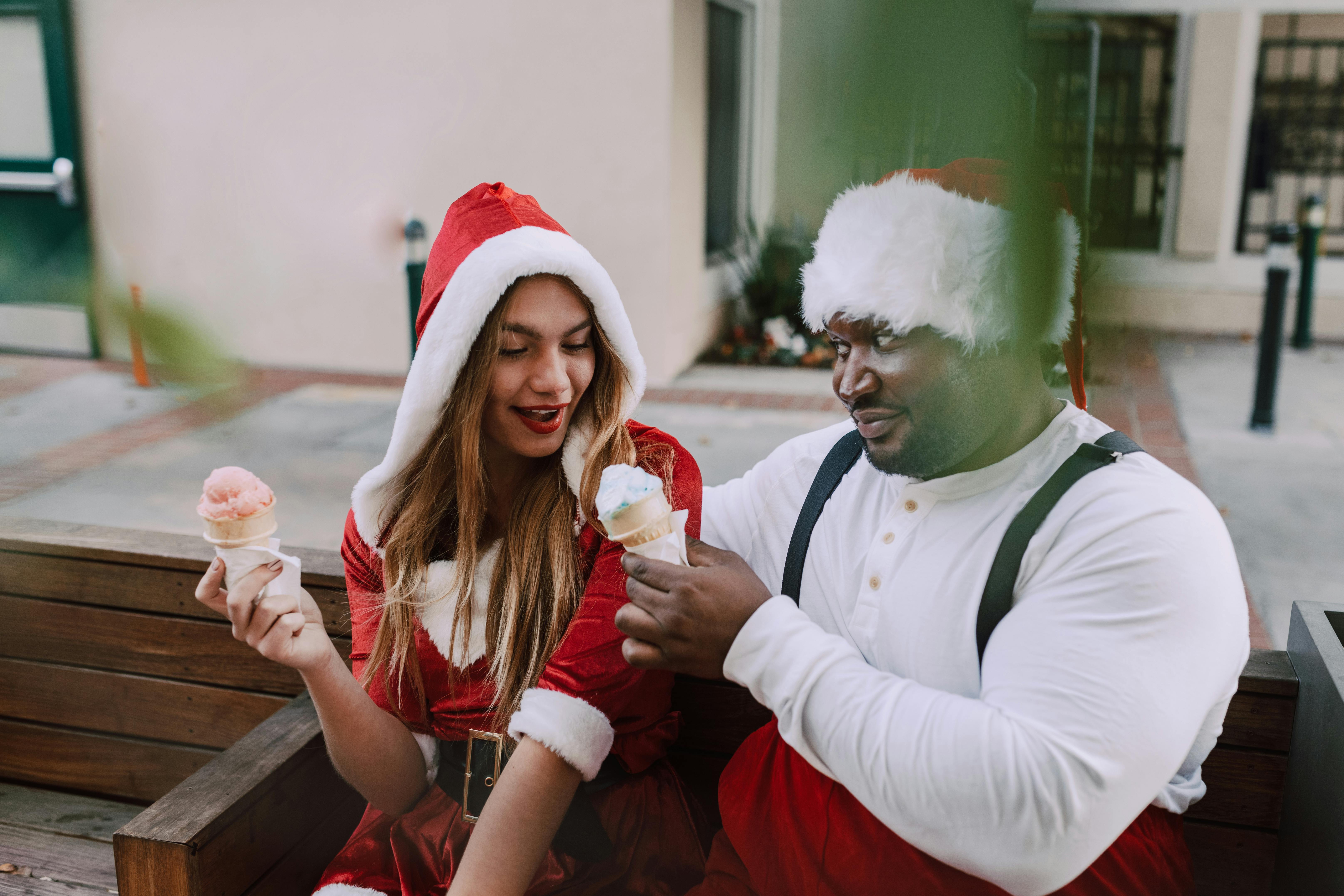 woman in white long sleeve shirt and red hat holding ice cream