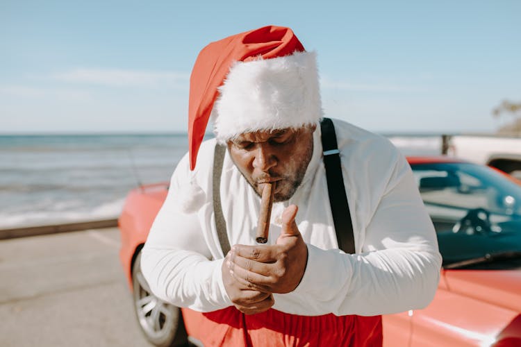 A Man In Santa Hat Smoking Tobacco