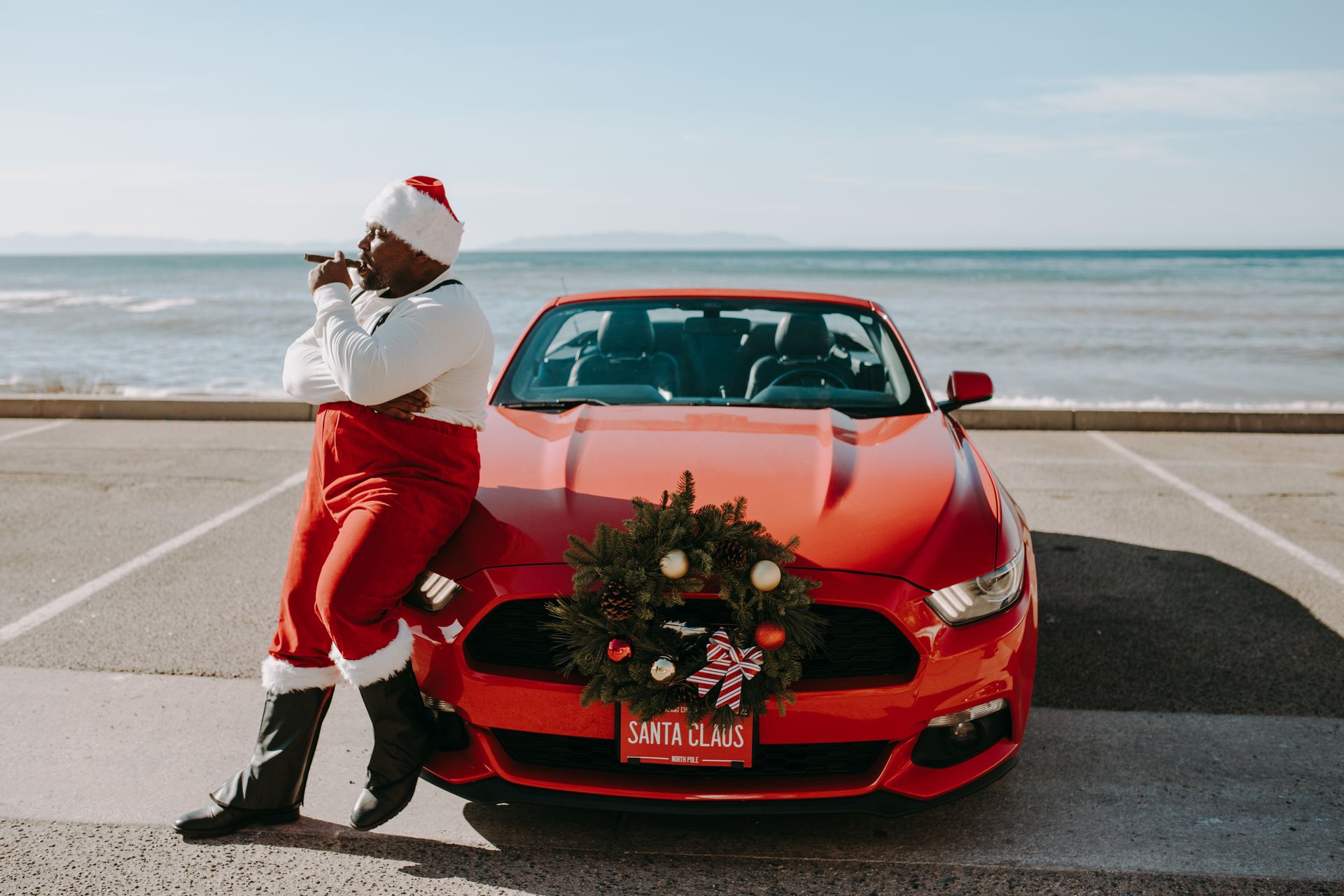 A Man in Santa Claus Costume Smoking Tobacco