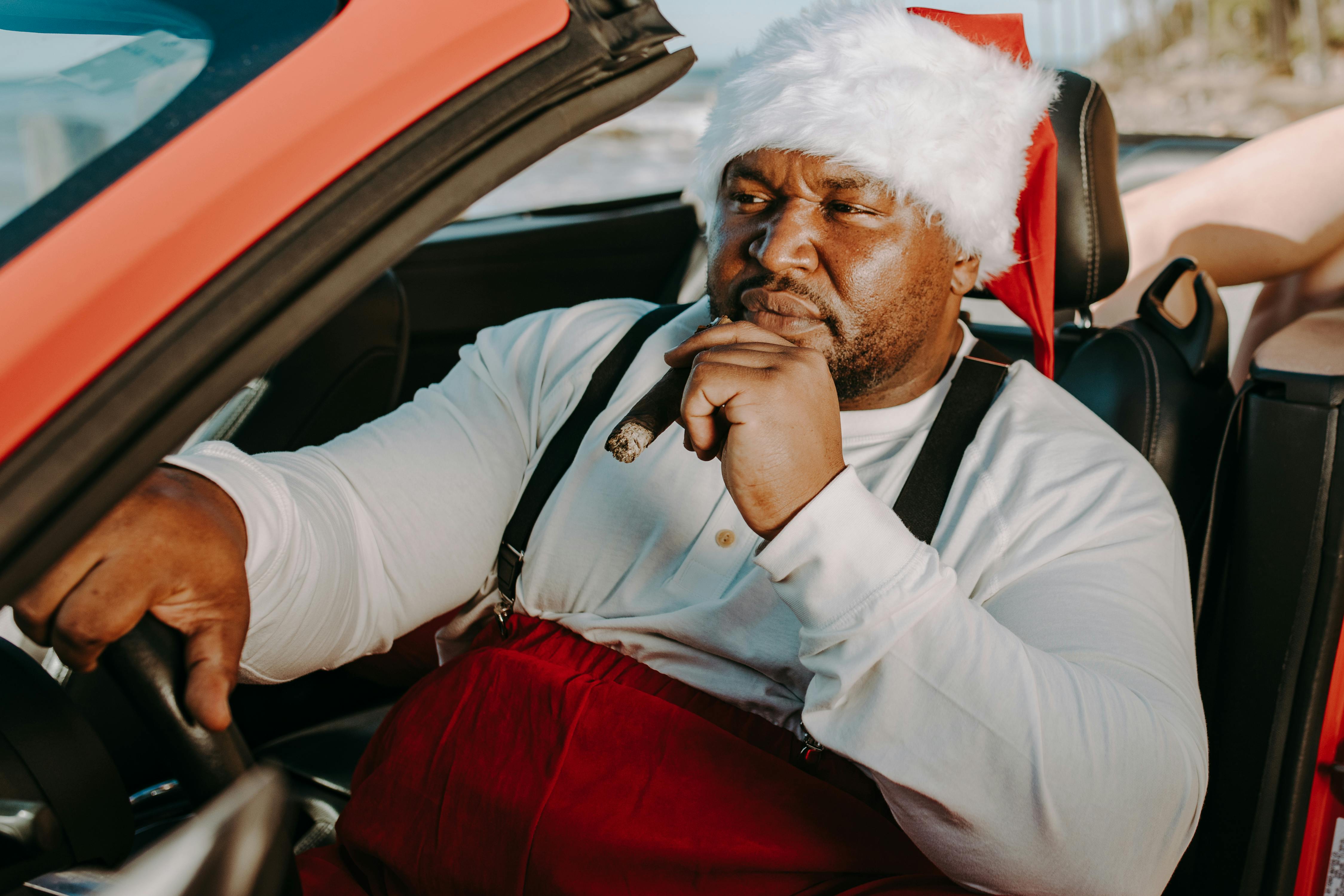 man in white long sleeve shirt sitting on car seat