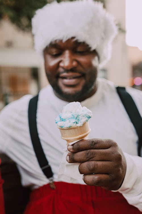 Man in Santa Outfit Holding Ice Cream Cone