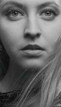 Stunning black and white portrait of a woman highlighting facial features and expression.