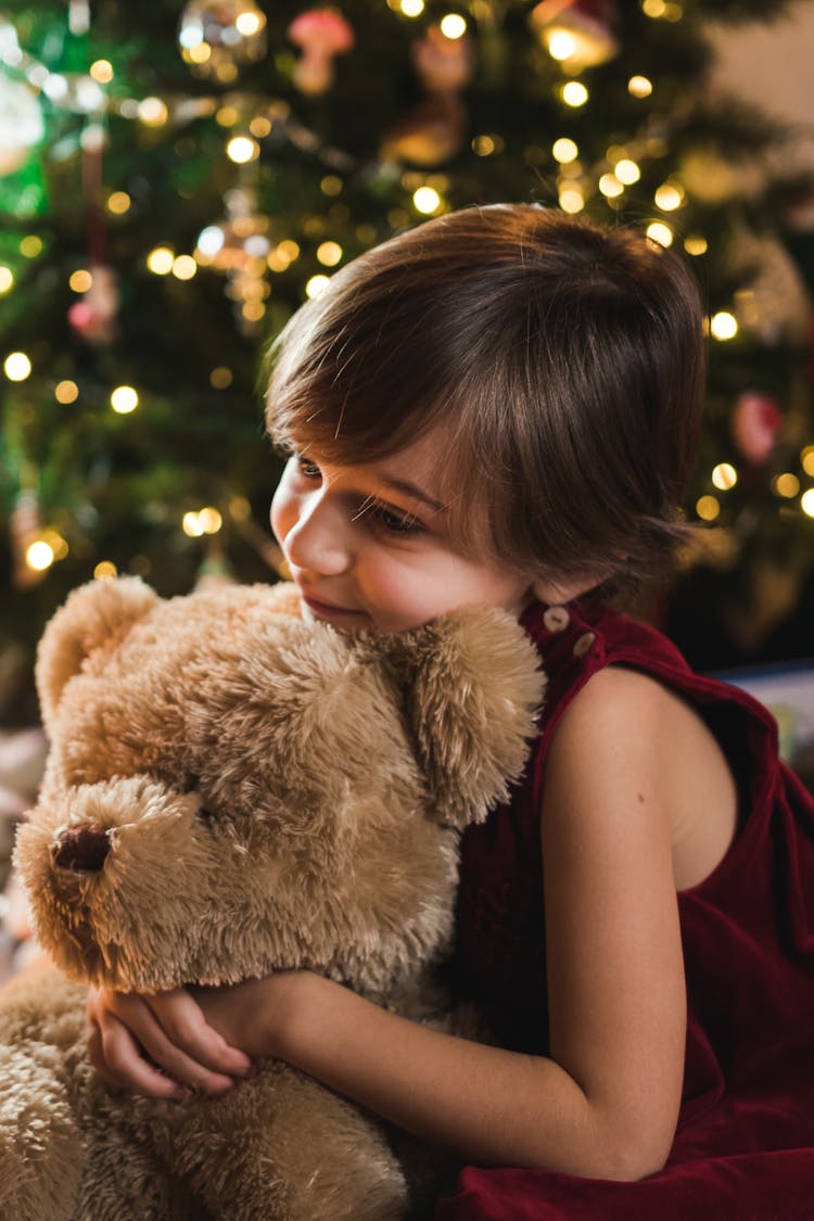 Child Hugging A Teddy Bear