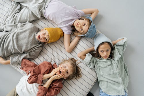 Free Children Lying Down a Bed Stock Photo