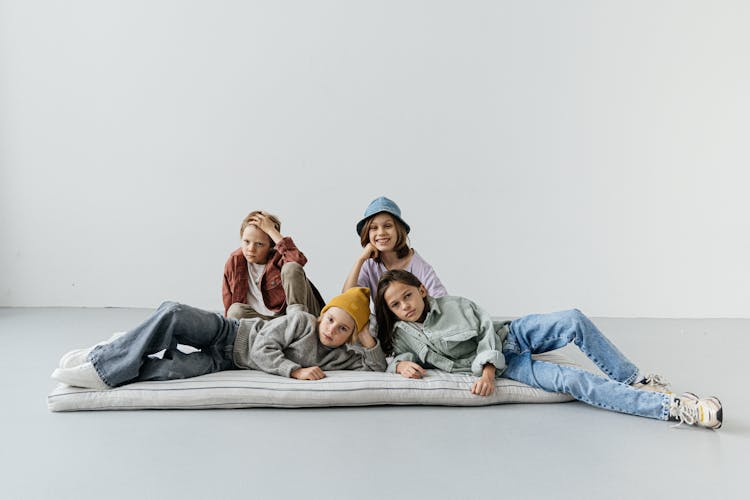 Kids Lying On A Bed On The Floor