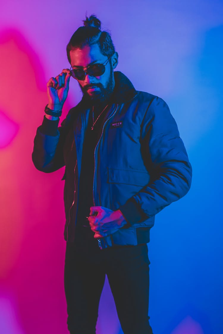 Cool Man In Sunglasses In Neon Lights In Studio