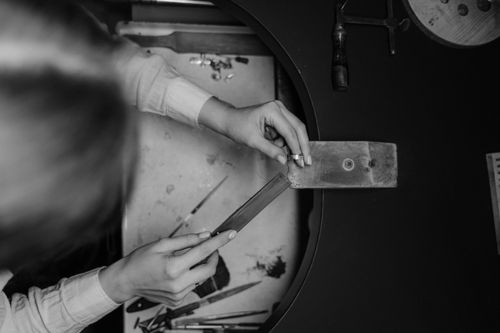 Free Artisan crafting jewelry at a workspace with tools in monochrome. Stock Photo