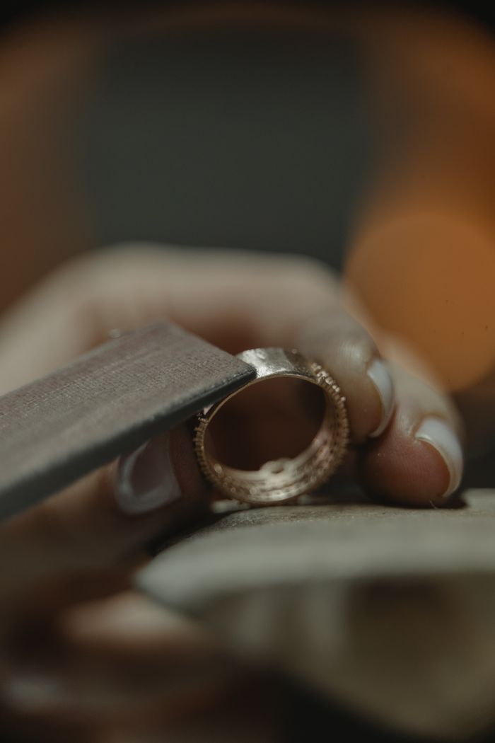 A gold ring being polished