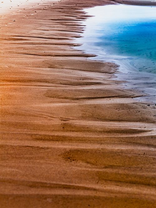 Free A tranquil view of the beach shoreline in Lubiatowo, Poland, showcasing golden sands and turquoise waters. Stock Photo