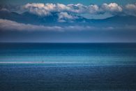Person in Body of Water Under Cloudy Sky