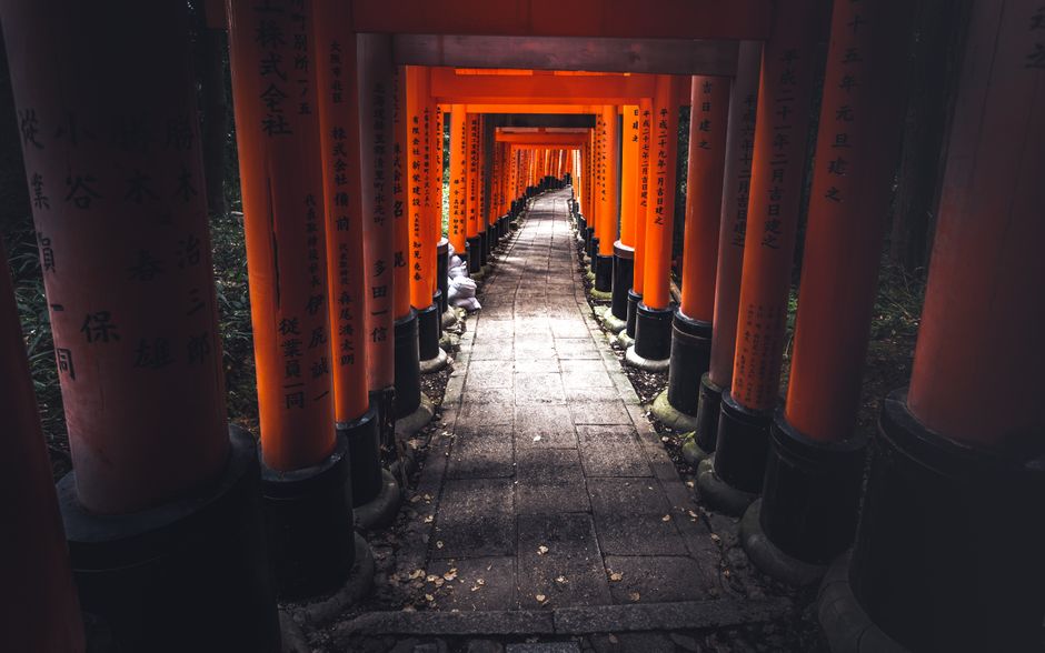 Captivating view of the iconic torii gate tunnel at Fushimi Inari Shrine in Kyoto, Japan.