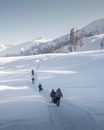 People Walking on Snow Covered Field