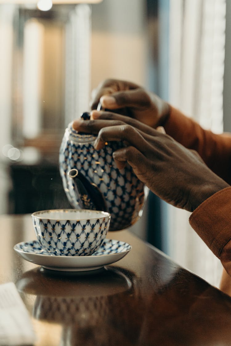 Close-Up Shot Of A Person Pouring A Tea