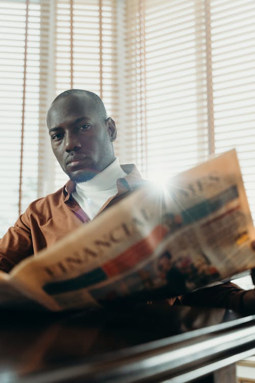 Free Man Holding a Newspaper Stock Photo