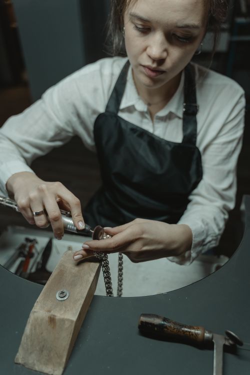 Free Skilled artisan crafting a necklace in a workshop, showcasing jewelry-making expertise. Stock Photo