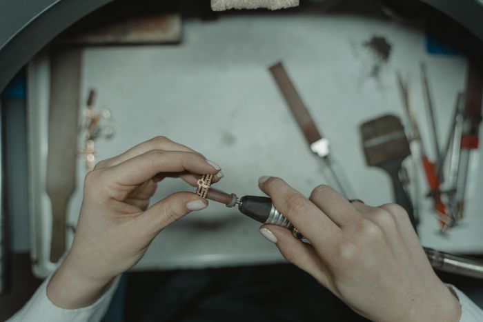 A jeweller working on a ring at the bench