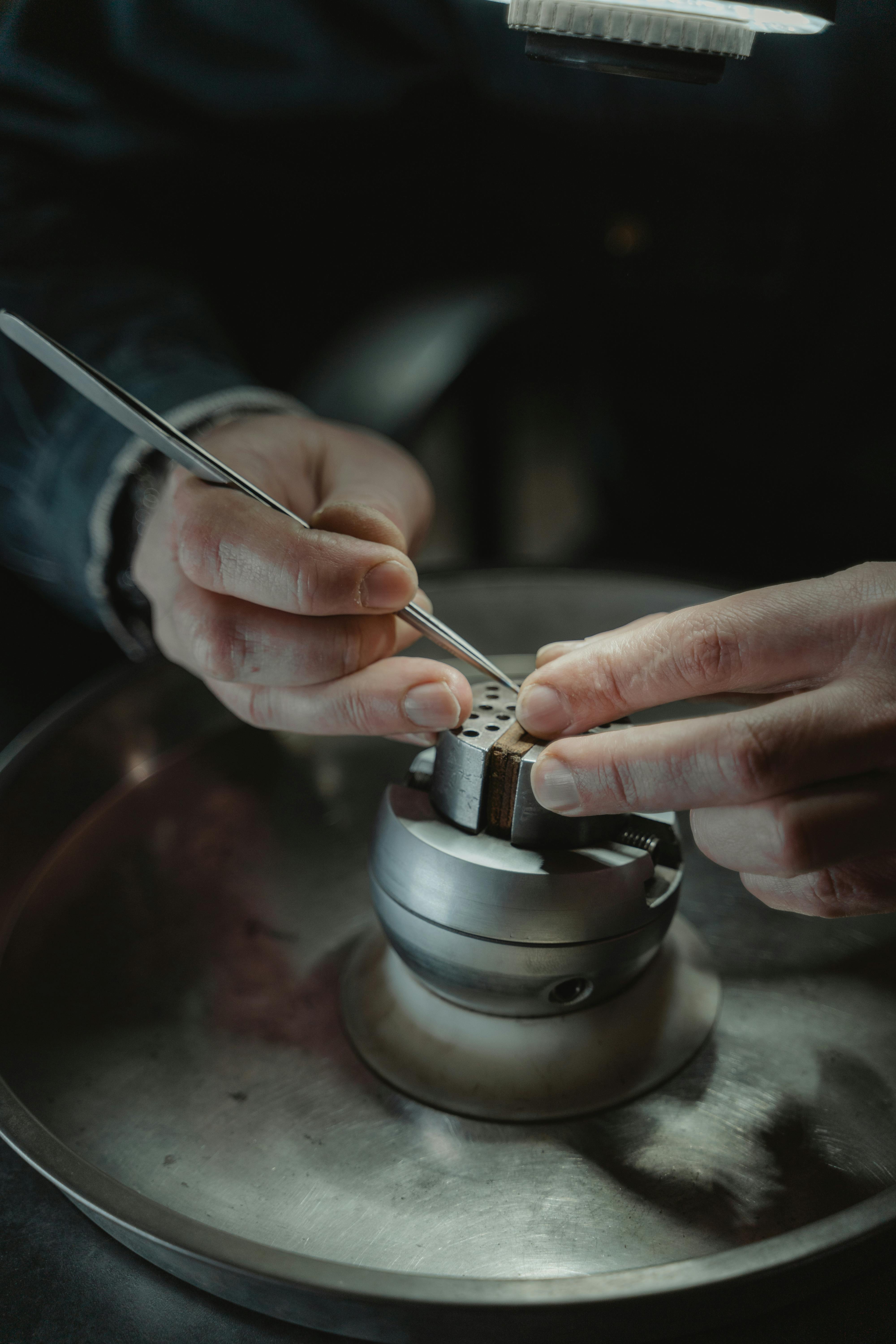 person holding silver steel tube