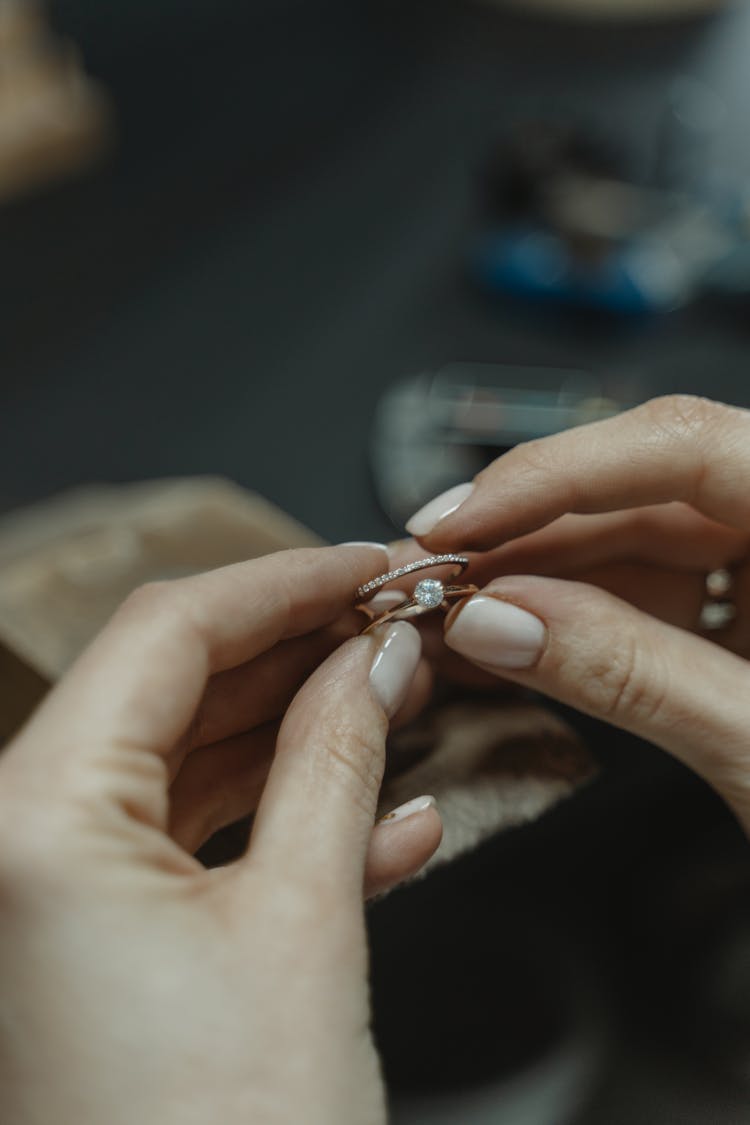 Person Holding A Gold Diamond Ring