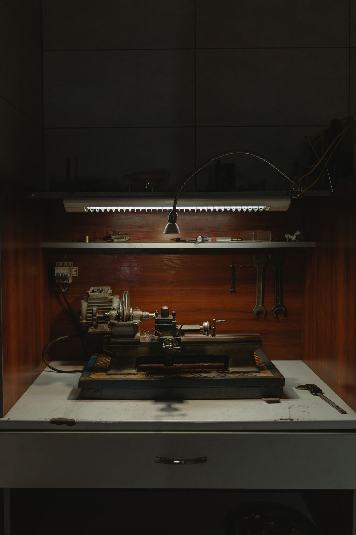 Dark workshop interior with vintage machinery and hanging lamps