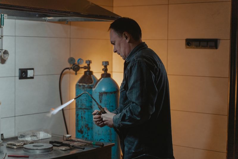 Plumber soldering copper pipes