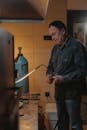 A Man Adjusting a Blowtorch
