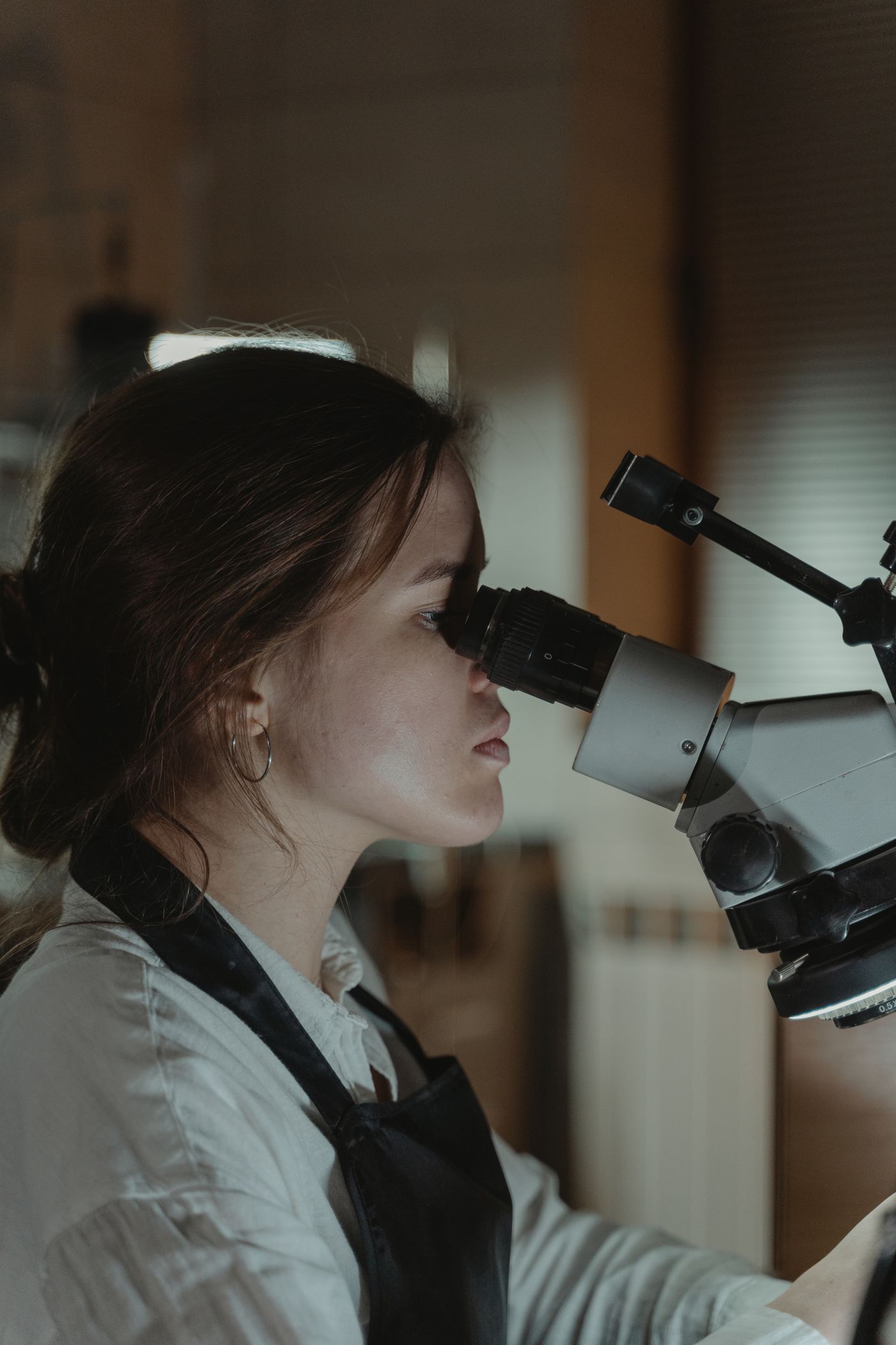 Trainee screening a smear at the microscope