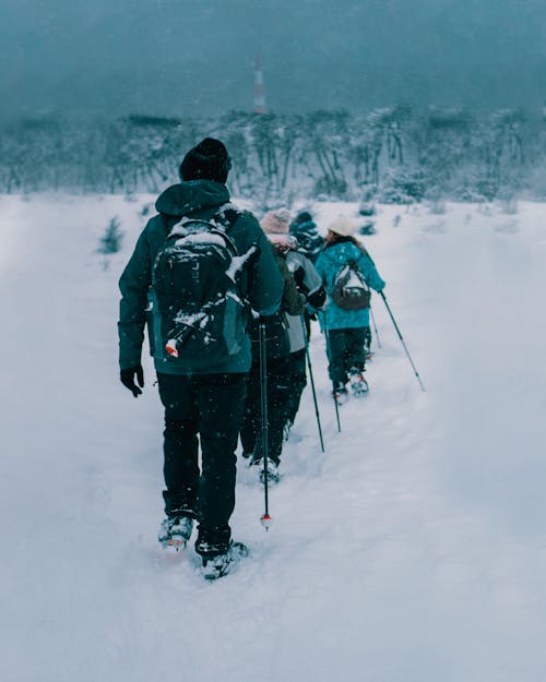 People Walking on Snow Covered Ground