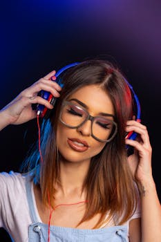 Portrait of a woman with headphones immersed in music, eyes closed, and enjoying the sound.