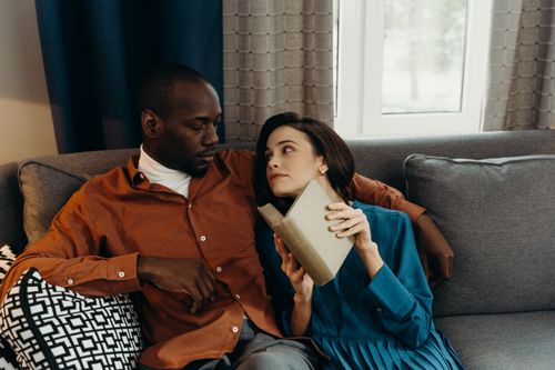 Man and Woman Sitting on Couch while Reading a Book · Free Stock Photo