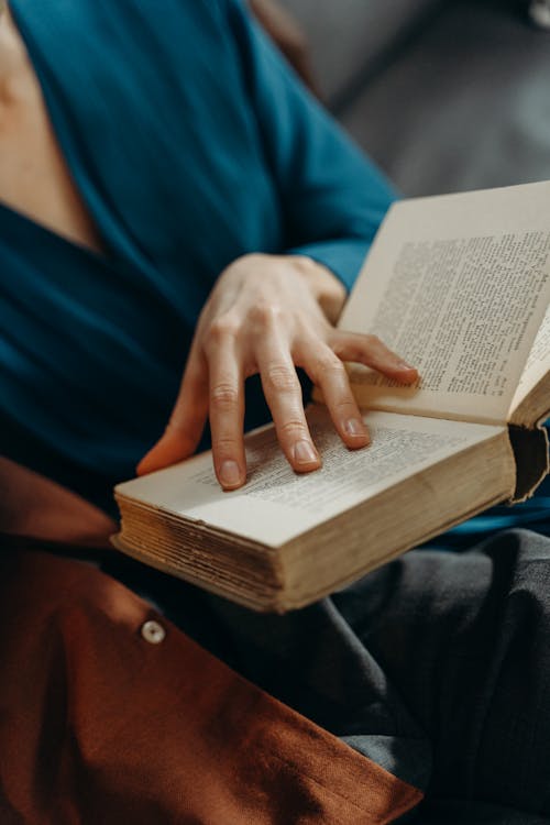 Free Close-Up Shot of a Person Reading a Book Stock Photo