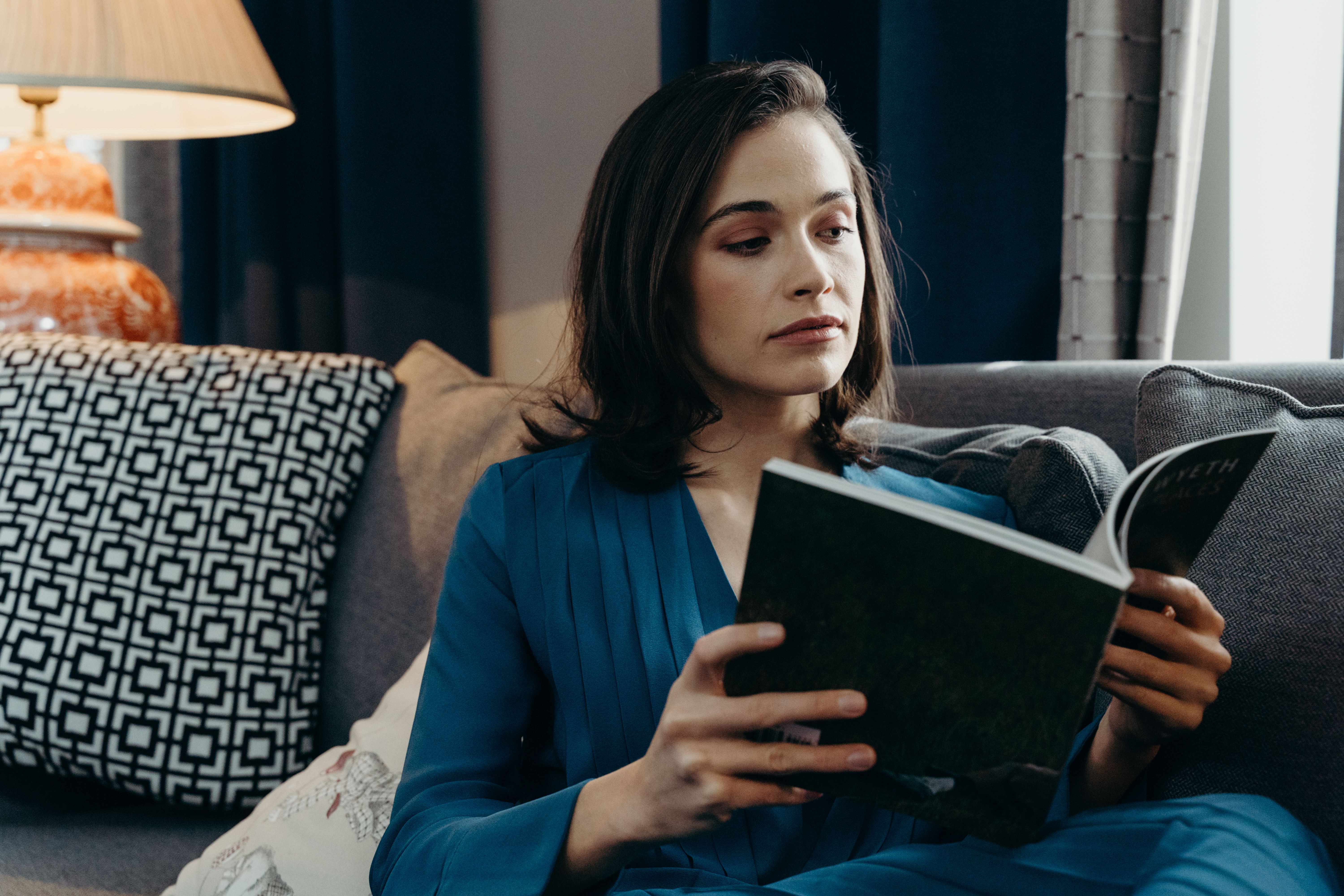 Woman reading a book in a cozy living room