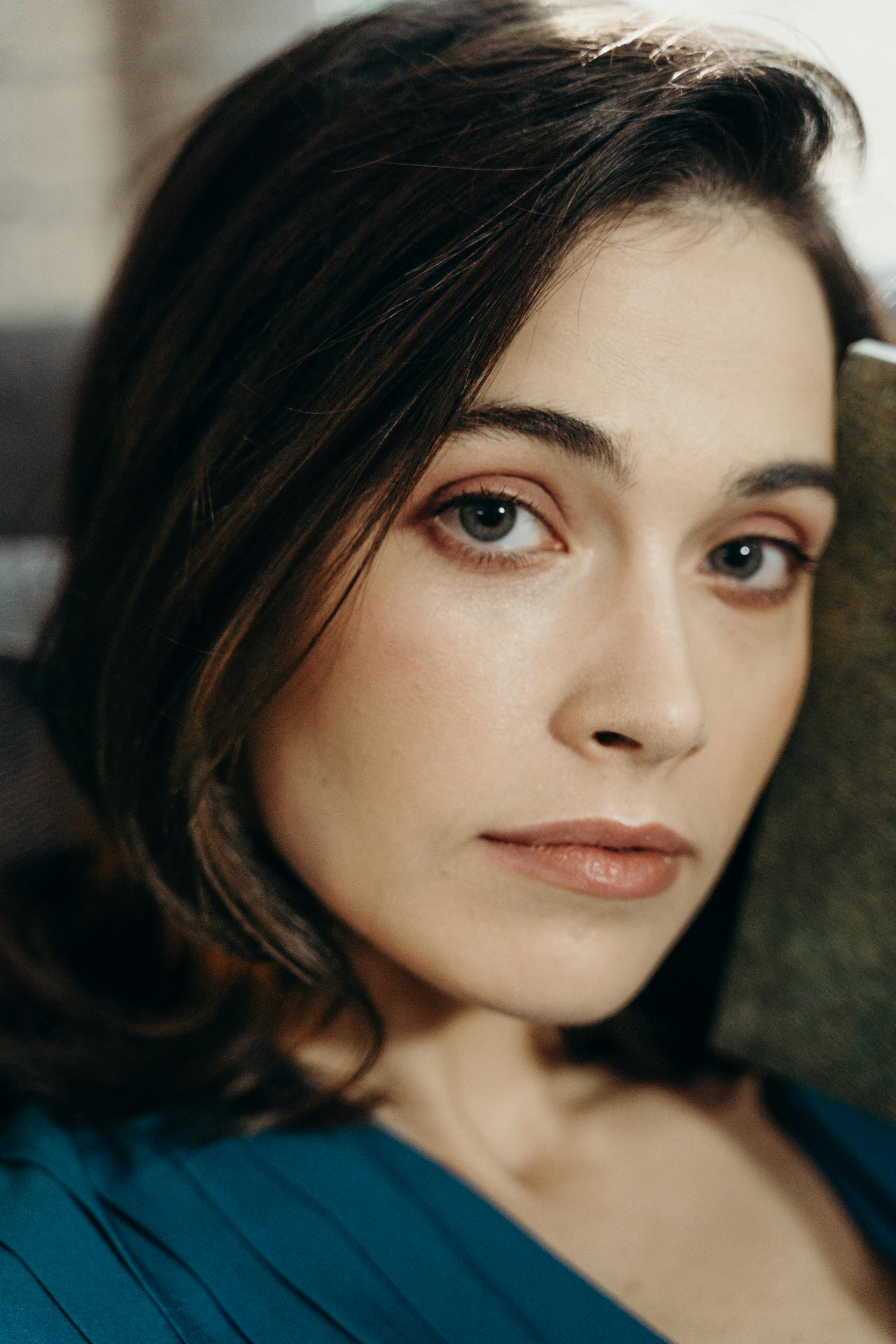 Close-up portrait of a woman with a soft gaze, showcasing natural beauty and elegance.