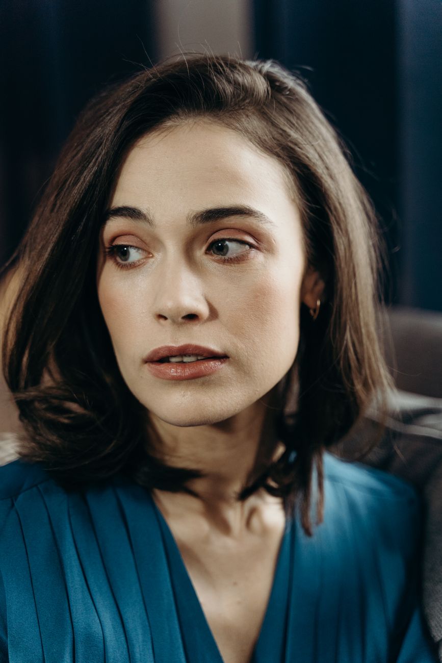 Stylish portrait of a woman in blue with an elegant expression, captured indoors. Perfect for fashion and lifestyle them