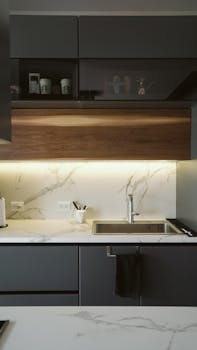 Sleek kitchen with marble countertops, stainless steel sink, and LED lighting for a modern touch.