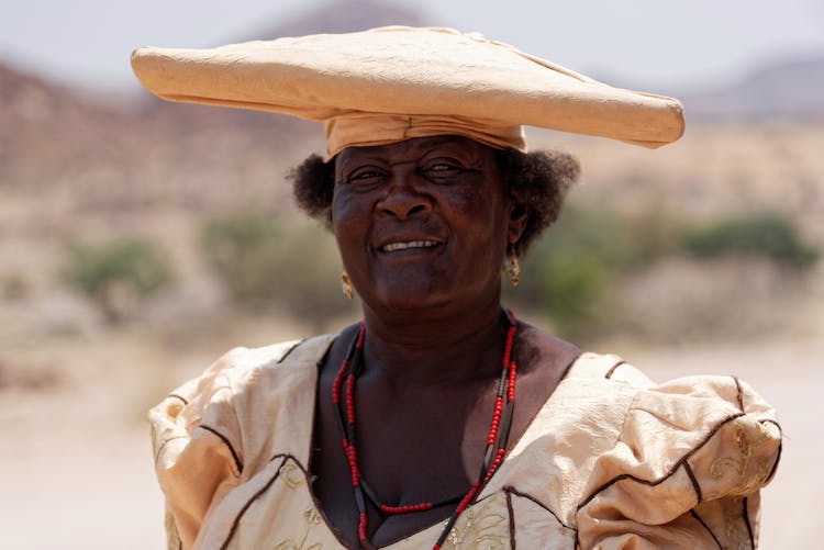 Woman Wearing A Big Yellow Hat Smiling