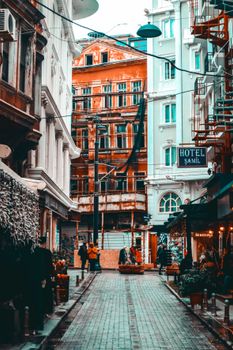 View of a vibrant narrow street surrounded by historic architecture in a cityscape.