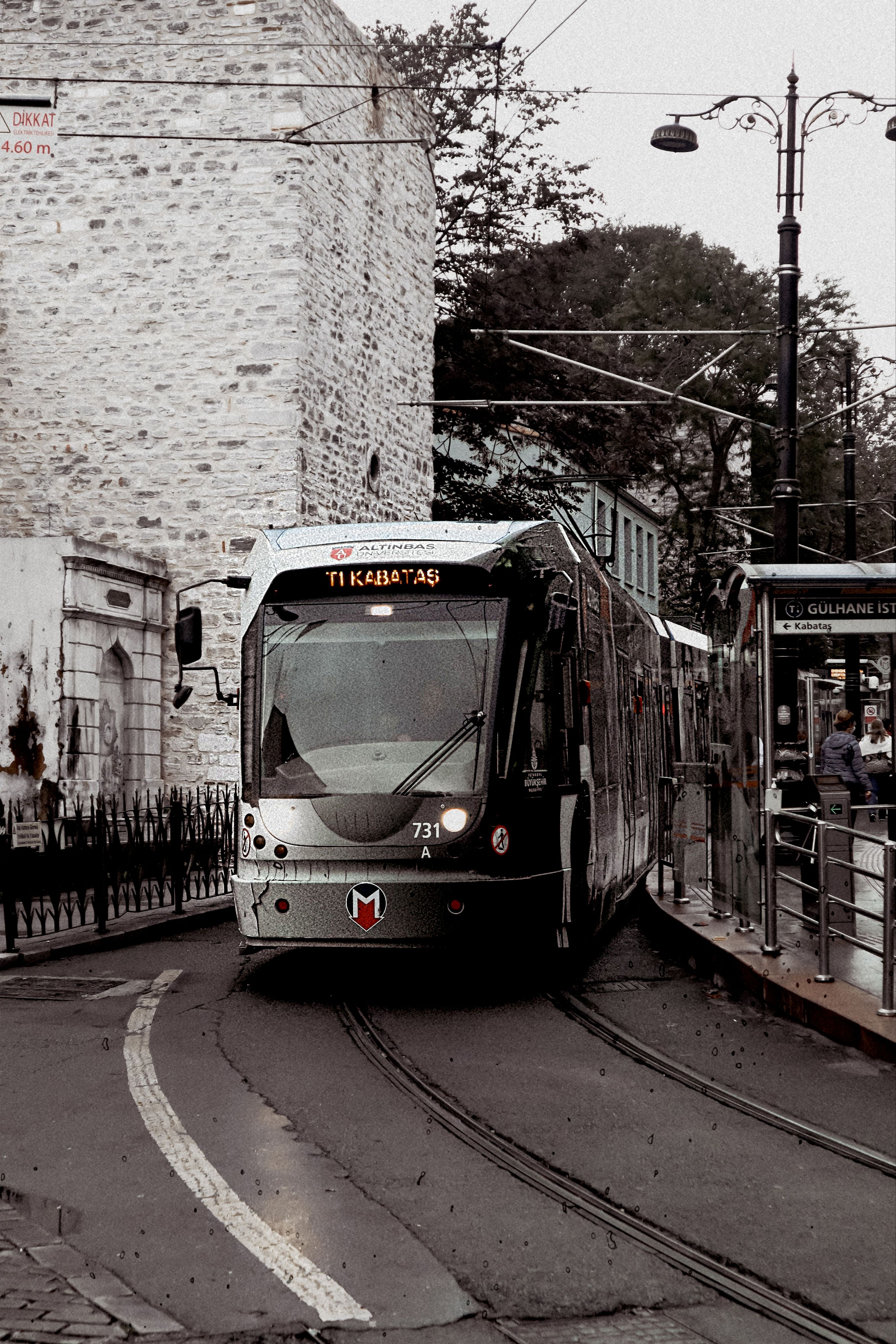 Tram T1 Kabataş on historic tracks in Gulhane, Istanbul, blending modern transport with heritage.