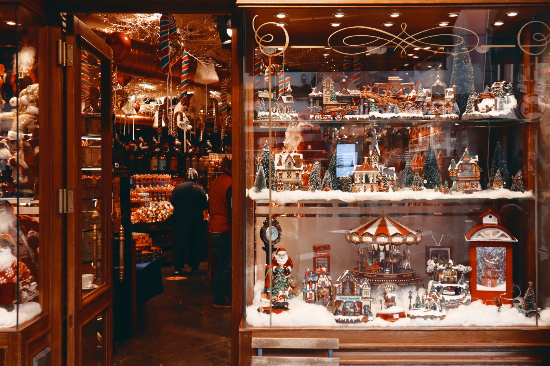 Festive boutique window showcasing Christmas figurines and decorations.