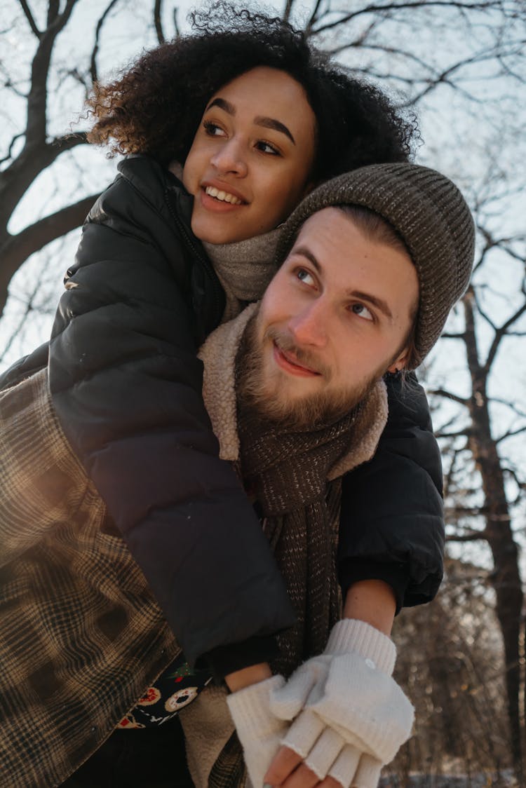 Man Carrying Woman At His Back