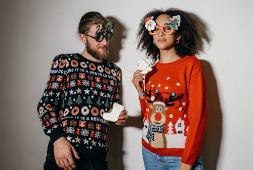 Free Man and Woman Wearing Christmas Sweaters Stock Photo