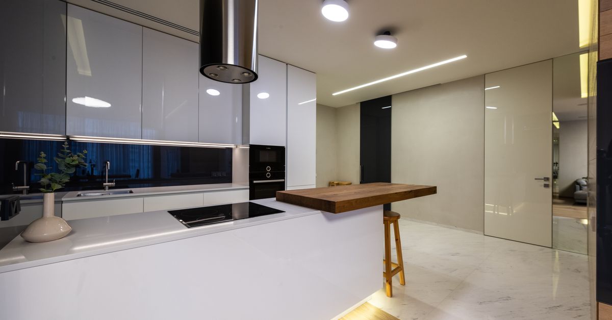 Bright modern kitchen with a clean counter, appliances and glossy cabinets