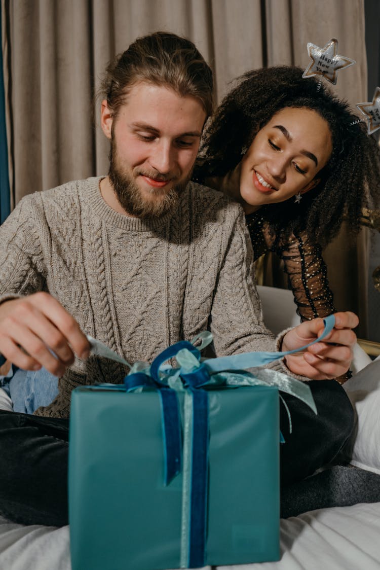 A Man Opening A Present