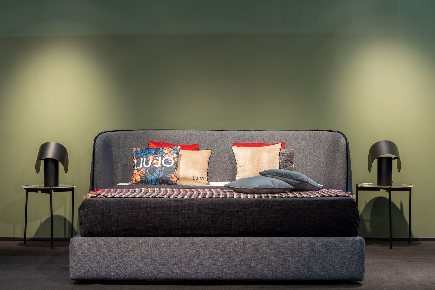 Contemporary blue-toned bed with paired bedside lamps and balanced low-level illumination