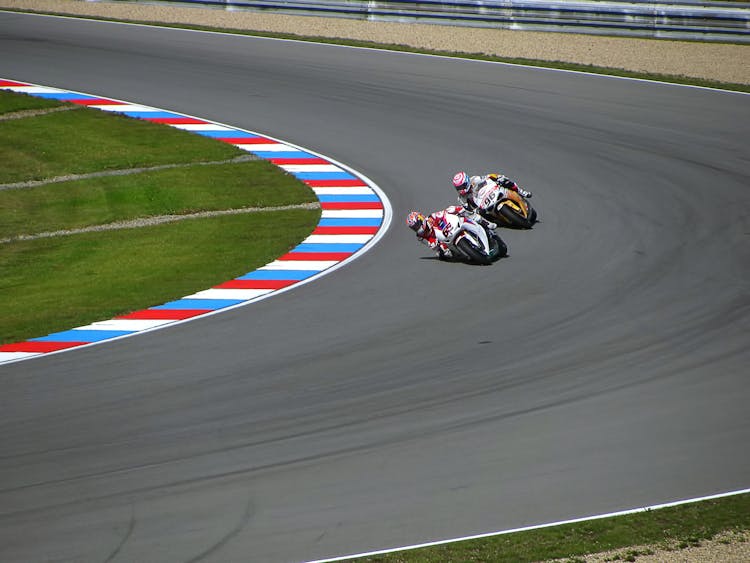 2 Motorcycle Racing On Asphalt Road During Daytime