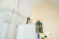 Priest Praying at the Pulpit