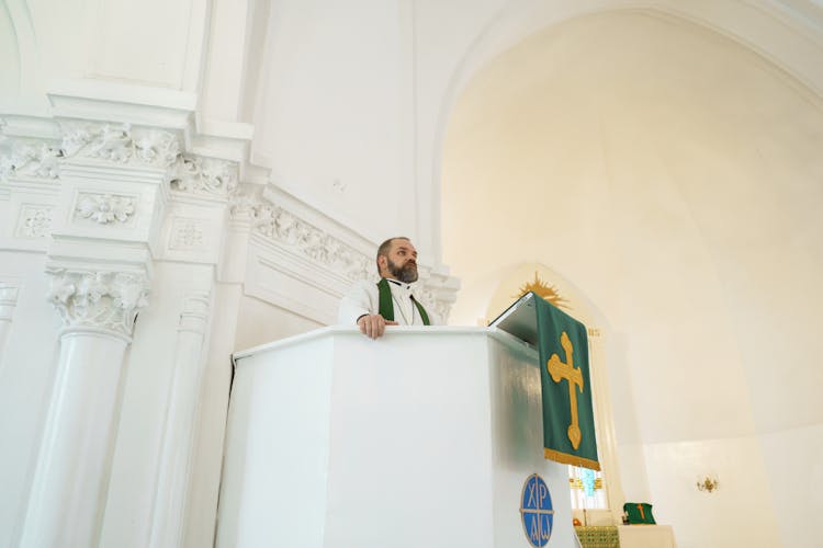 Priest Praying At The Pulpit 